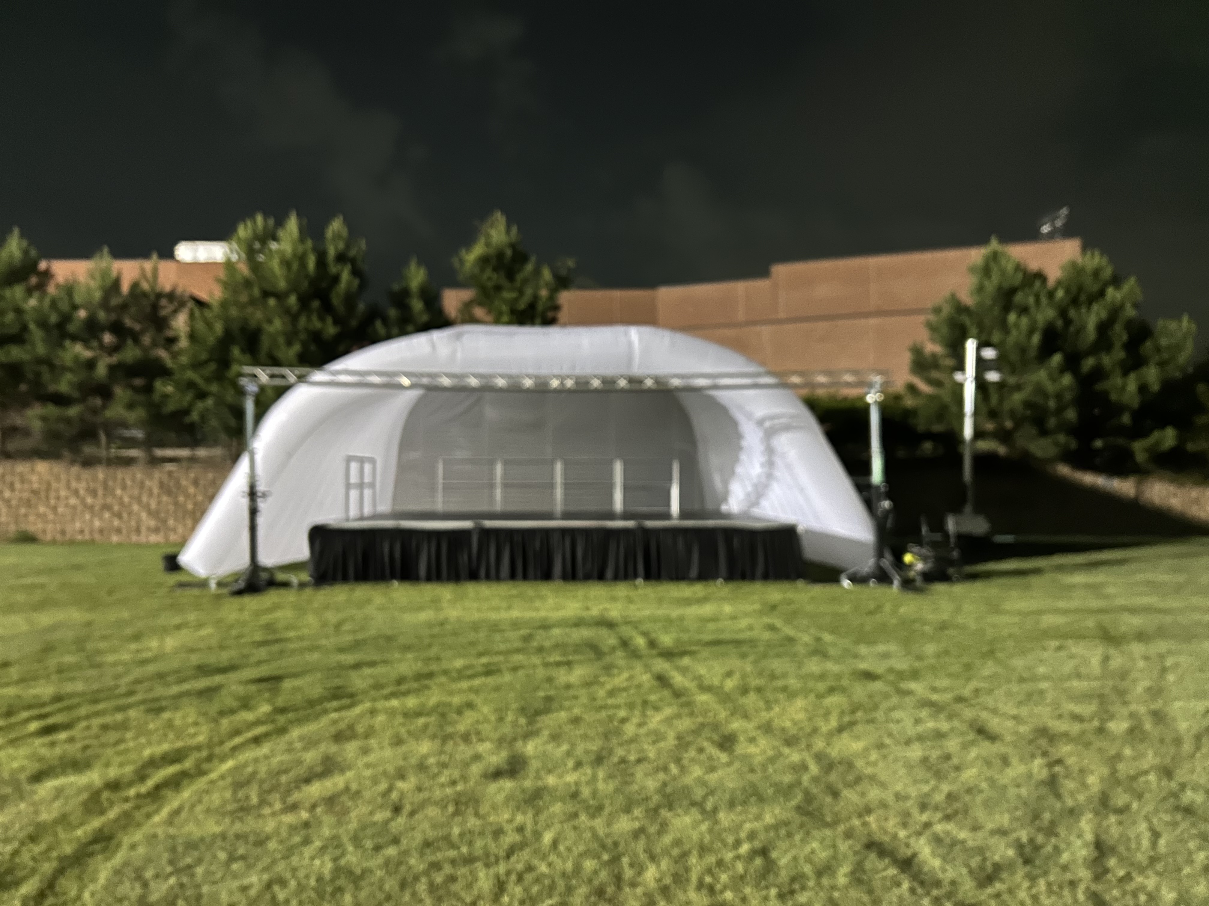 Outdoor inflatable stage setup at night