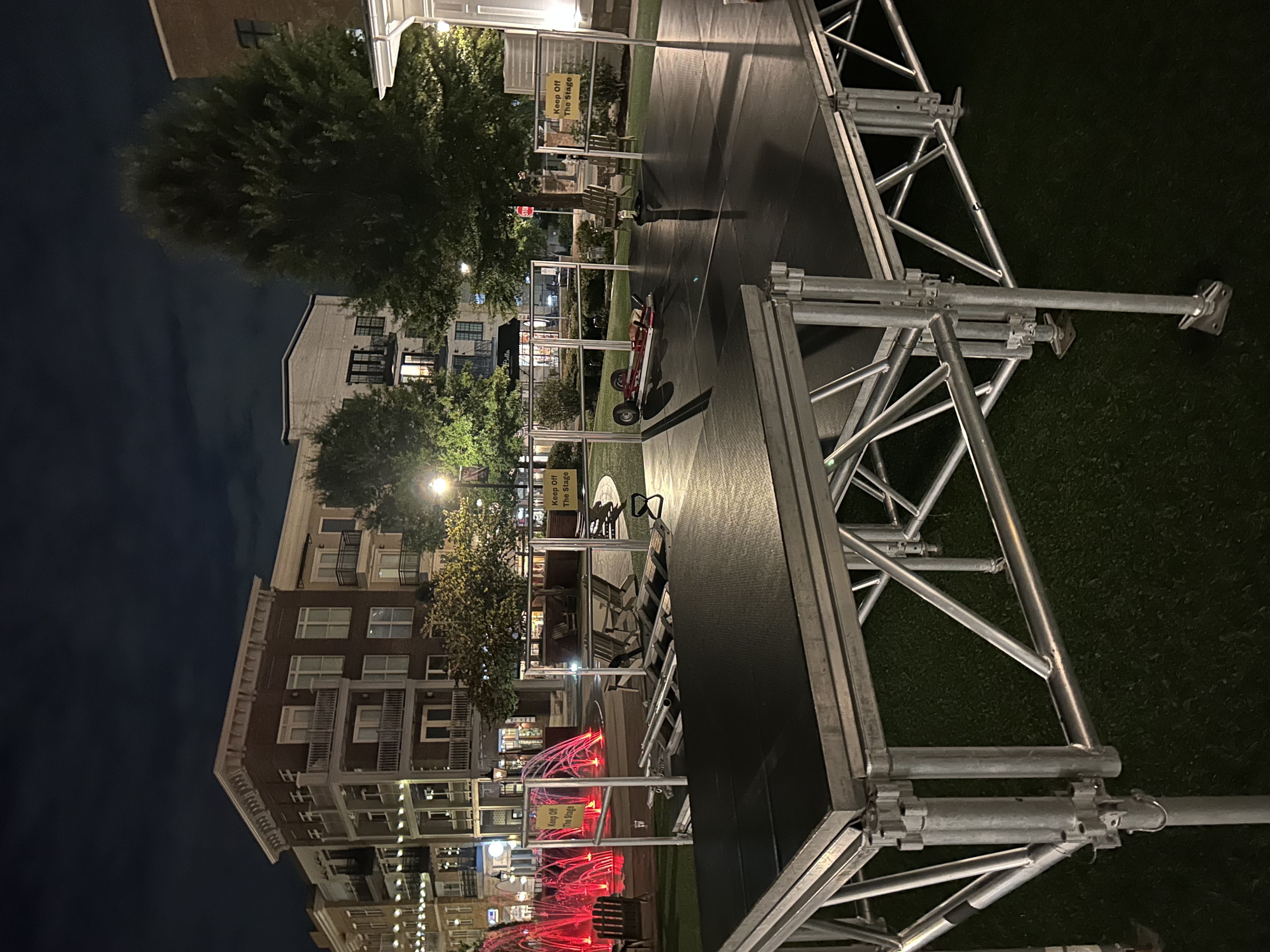 Outdoor stage truss setup at night