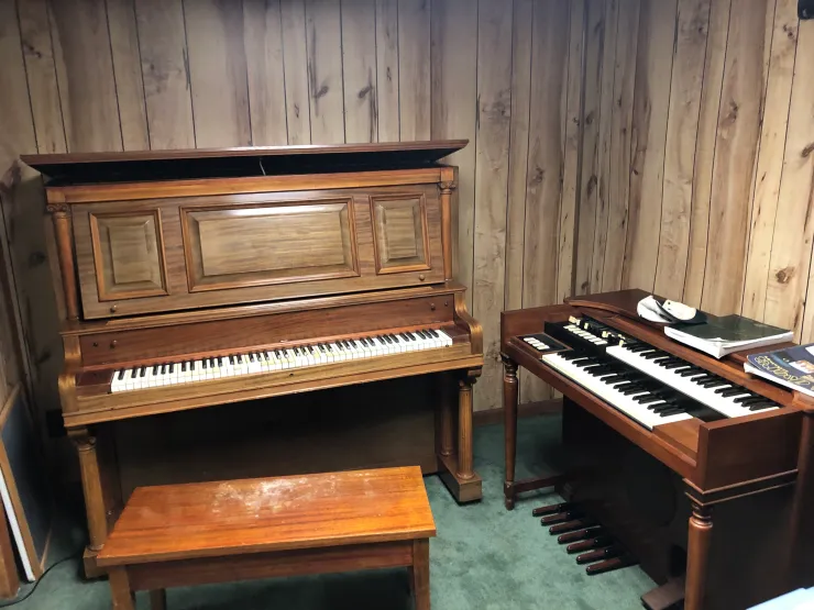 Upright piano and organ keyboard in studio